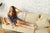 Young woman in loungewear resting on a sofa