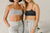 Two models wearing joggers and sports bras