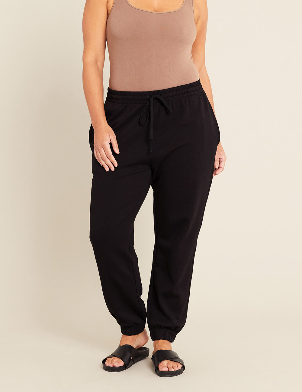 Gender-Neutral-Cuffed-Sweat-Pants-Black-Female-Front.jpg